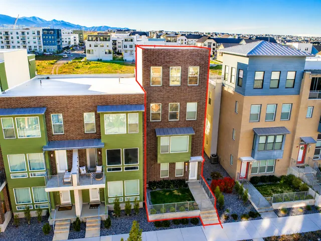 Multi-story townhouse with a brick facade