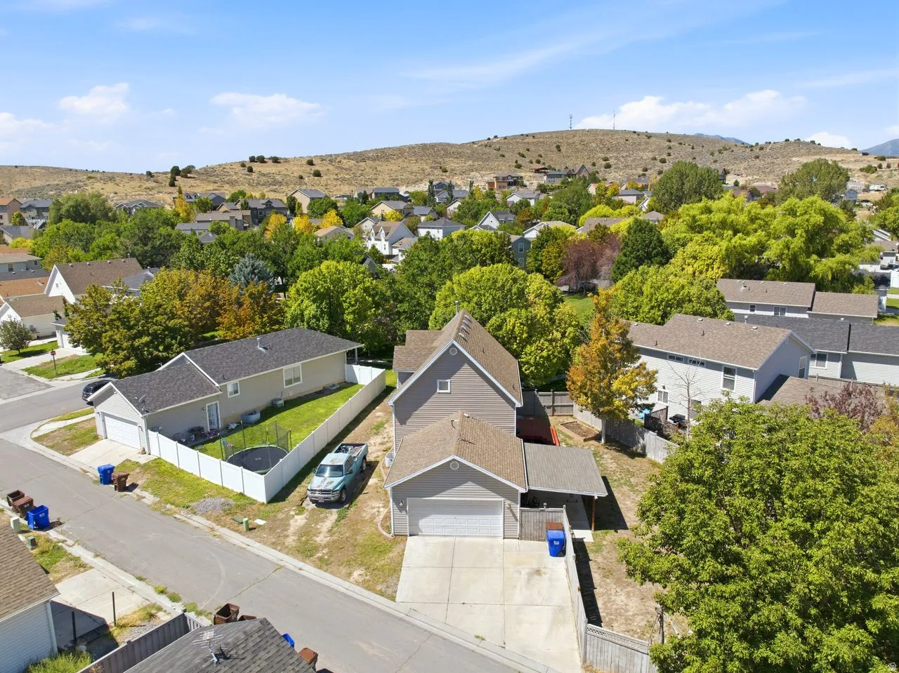 Aerial perspective of a neighborhood with diverse residential structures and mature landscaping