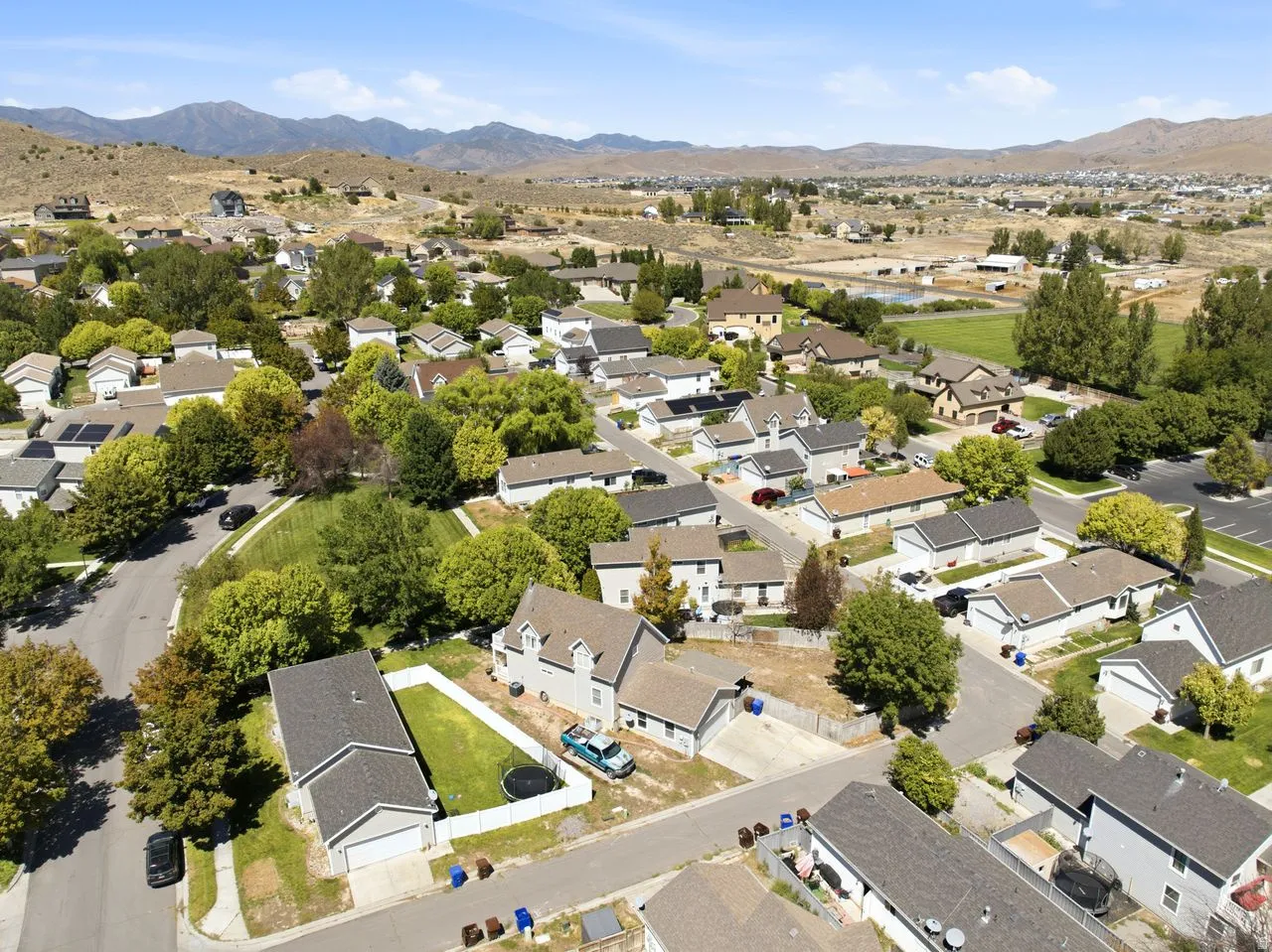 Expansive neighborhood with diverse residential architecture and mature landscaping