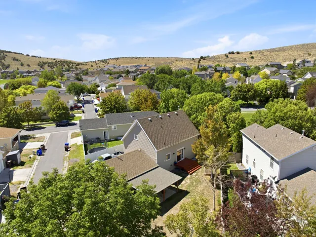 Hills surrounding a residential community with mature trees and paved streets