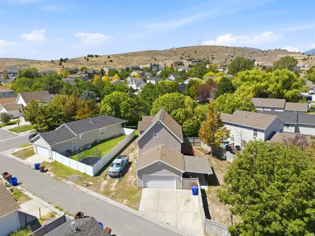 Aerial perspective of a neighborhood with diverse residential structures and mature landscaping