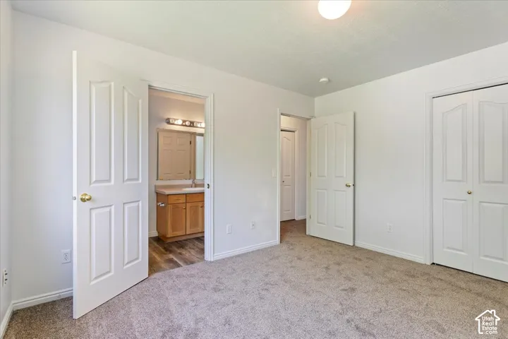 Carpeted room with white paneled doors and a semi-flush mount ceiling light