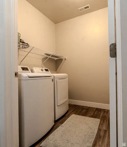 Utility space featuring wood-finish flooring and a wire shelving unit
