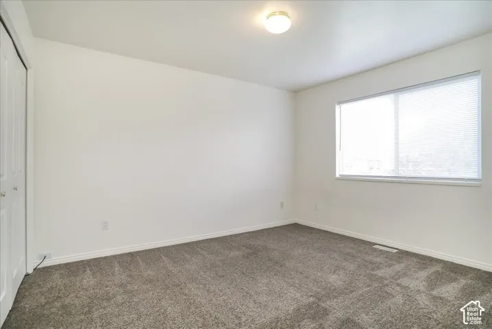 Recessed window with horizontal blinds, flush mount ceiling light, and neutral wall tones