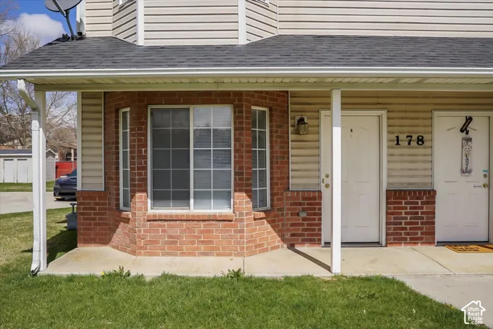 Brick and siding exterior with a covered porch