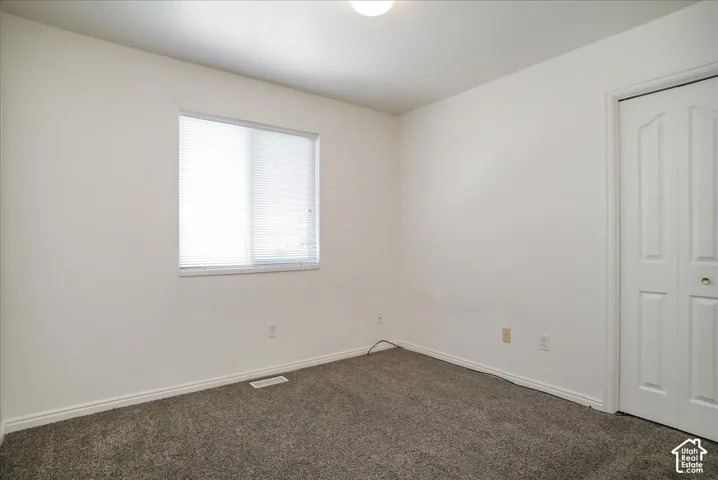 Recessed lighting, wall-to-wall carpeting, window with blinds, and bi-fold closet doors