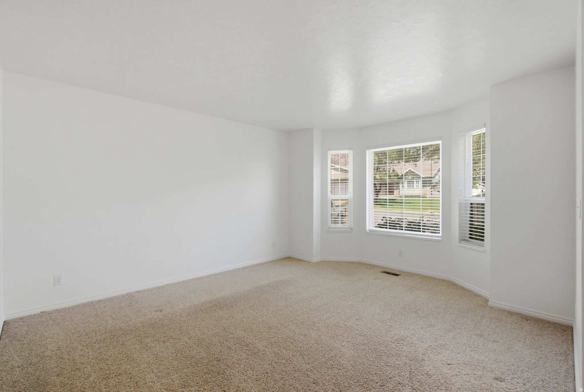 Bay window with multiple panes and white blinds