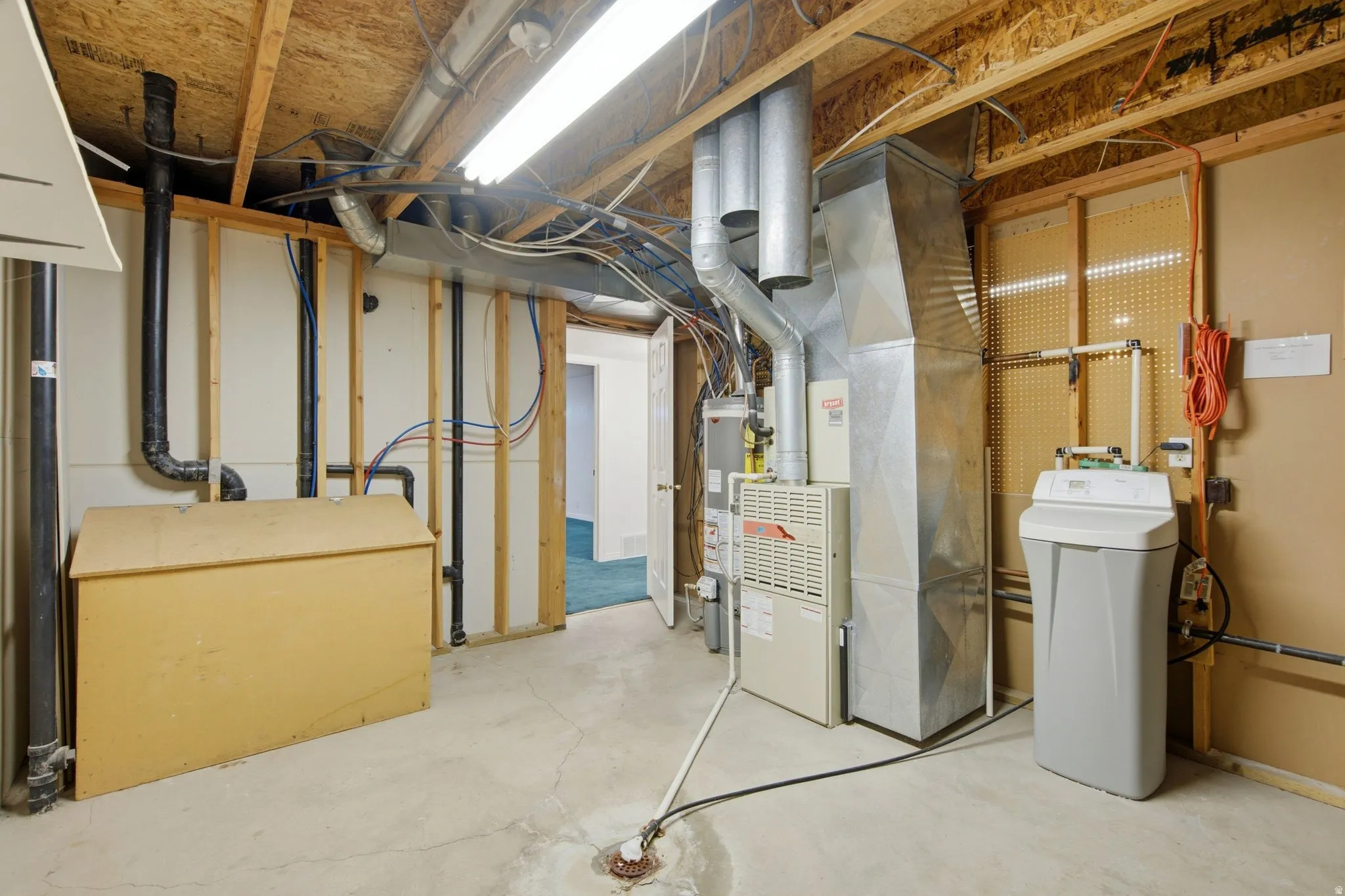Concrete flooring with exposed ceiling joists and utility piping