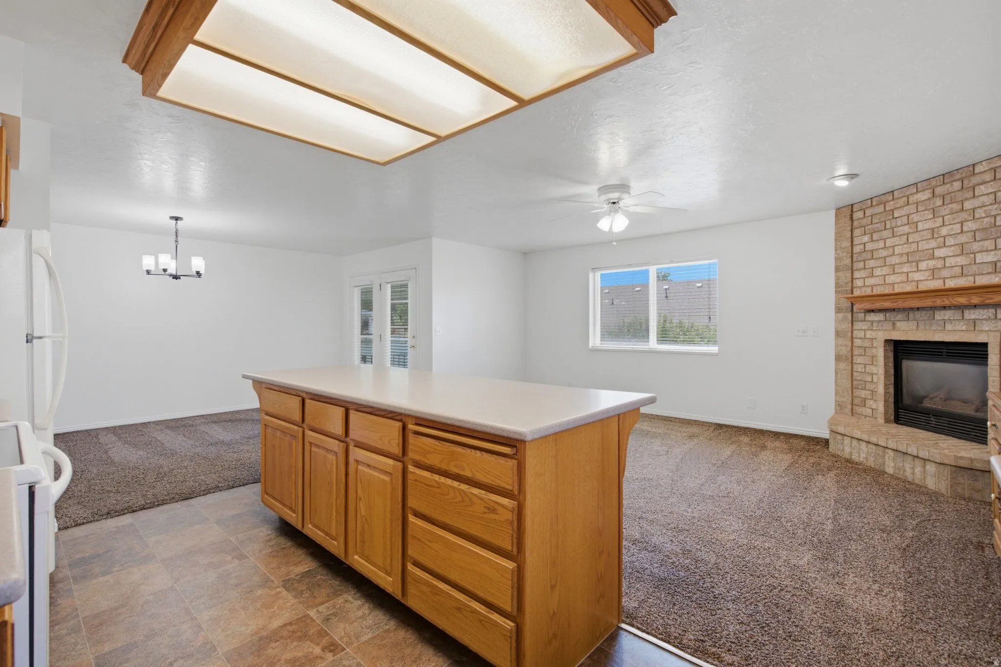 Kitchen island with wood-finish cabinetry and light-toned countertop