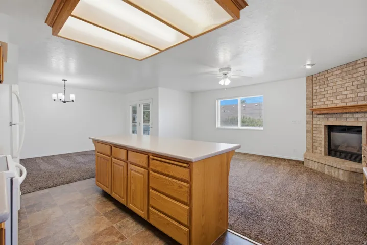 Kitchen island with wood-finish cabinetry and light-toned countertop
