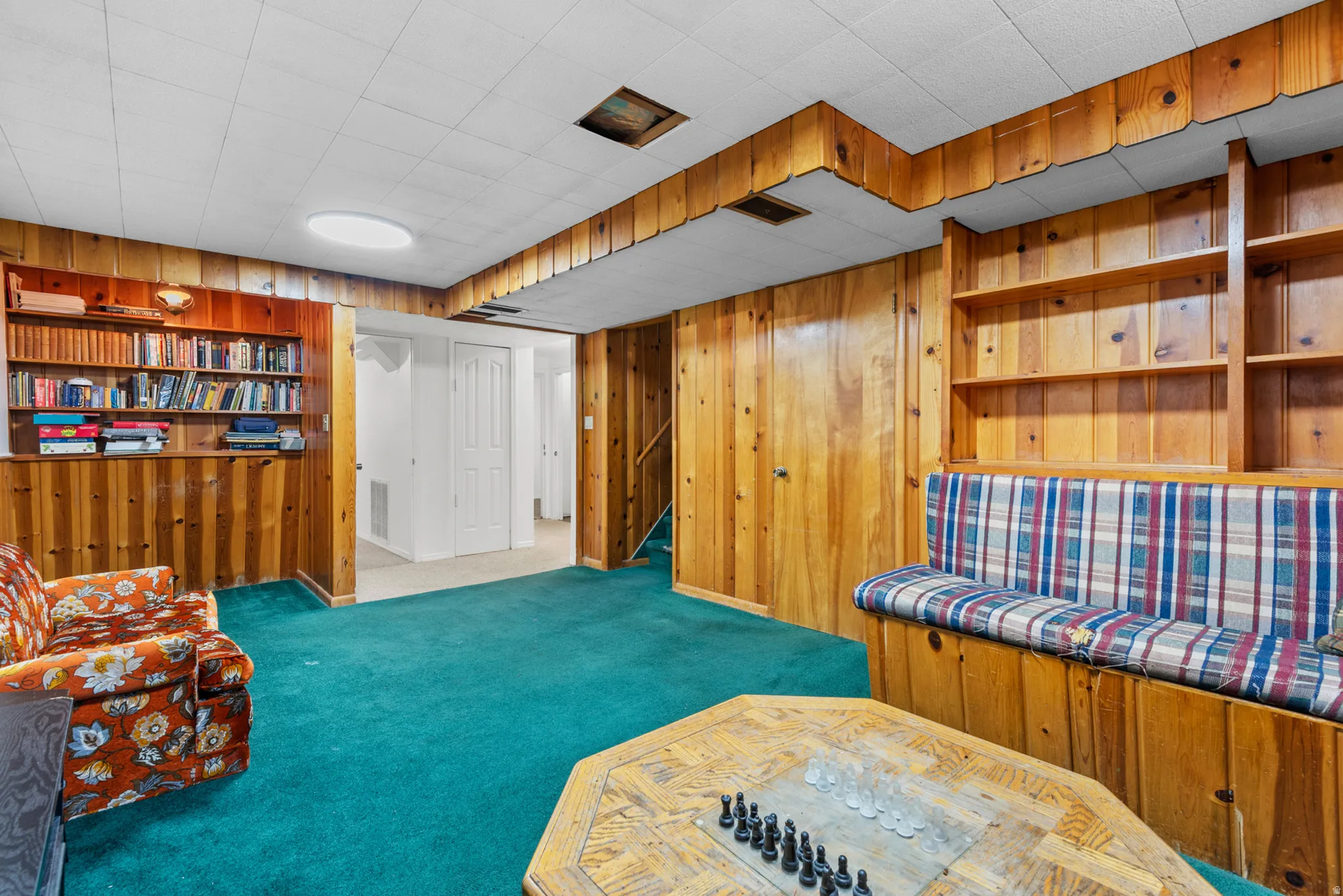 Wood-paneled walls and built-in shelving offer dedicated storage