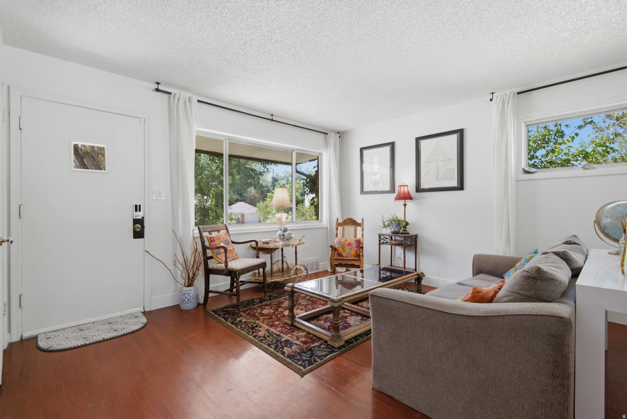 Hardwood flooring throughout, large picture window and second window for lots of light, and frehsly painted crisp white walls
