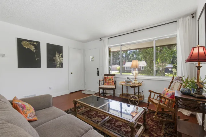 Hardwood flooring with a large window and lots of light