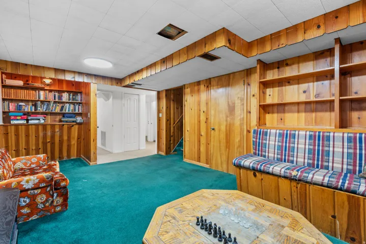 Wood-paneled walls and built-in shelving offer dedicated storage