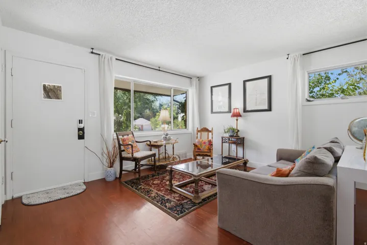Hardwood flooring throughout, large picture window and second window for lots of light, and frehsly painted crisp white walls