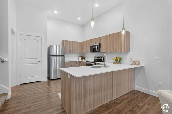 Elevated kitchen finishes with tile backsplash and quartz counters. *Refrigerator not included*