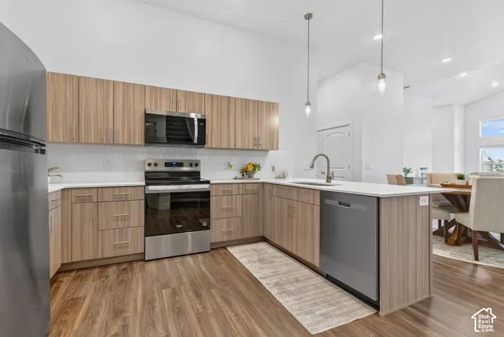 Elevated kitchen finishes with tile backsplash and quartz counters. *Refrigerator not included*