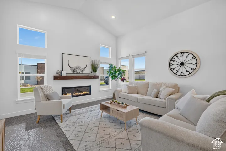 Living room with cozy fireplace and vaulted ceilings
