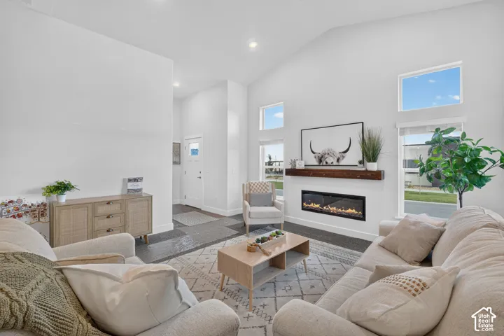 Living room with cozy fireplace and vaulted ceilings