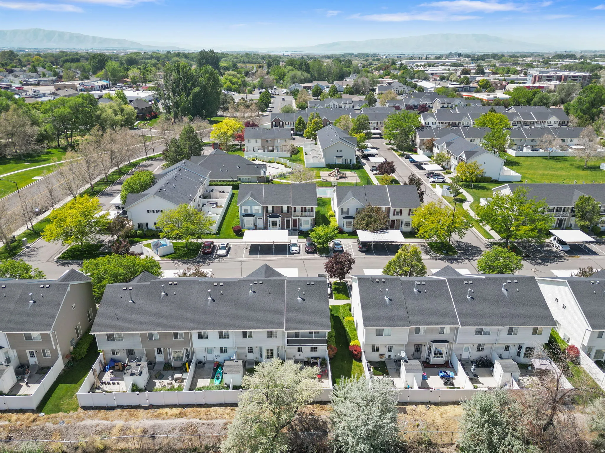 Townhome community with mature landscaping and mountain backdrop