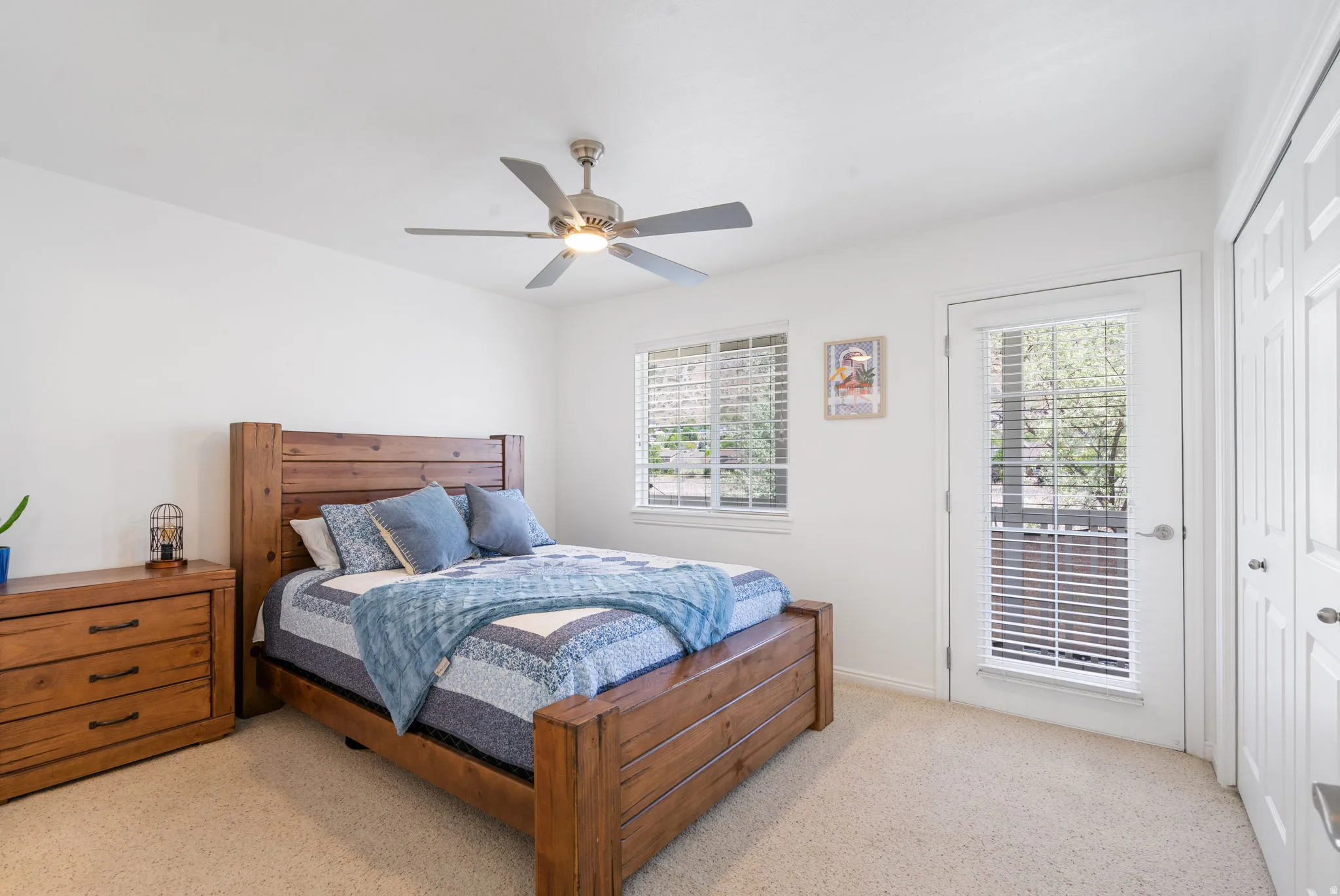 Window with blinds, ceiling fan, and white painted walls