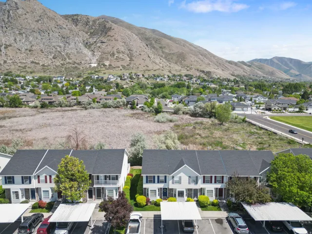 Townhome community featuring covered parking and mature landscaping