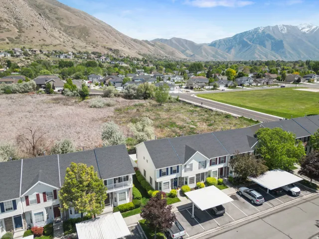 Townhome-style residences featuring dark shingle roofing and mountain scenery