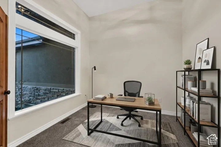 Large picture window with transom, neutral wall tones, and carpeted flooring