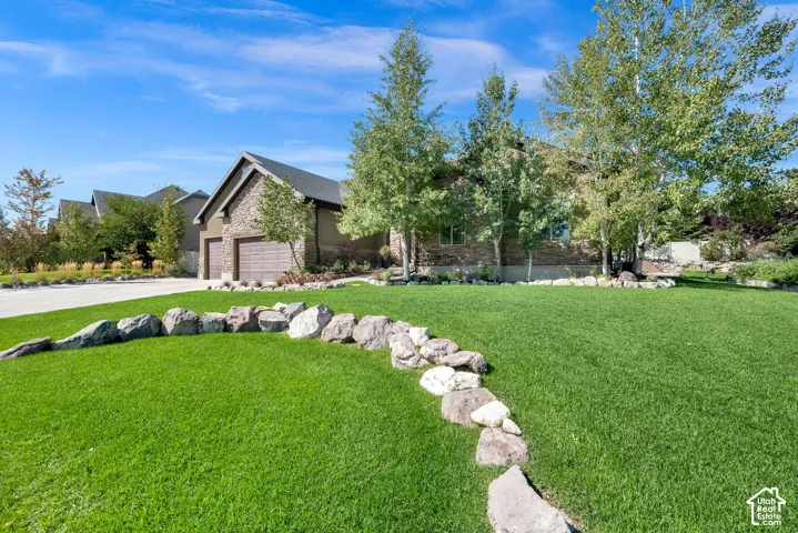 Stone veneer exterior with a gabled roofline and attached two-car garage
