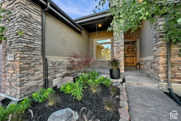 Stacked stone and stucco exterior with a custom wood entry door