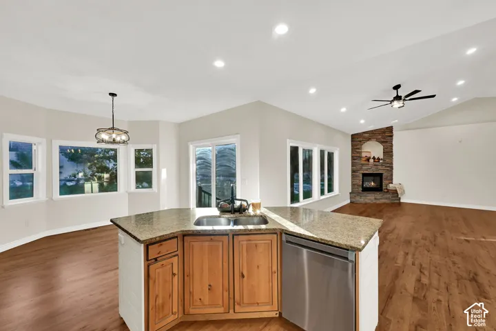 Kitchen island with granite-finish countertop and integrated stainless steel dishwasher