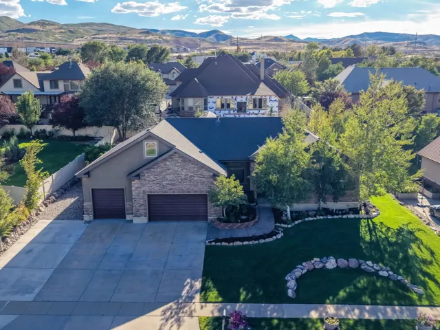 Stone and stucco exterior with an attached two-car garage