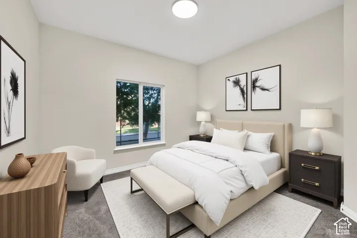Vaulted ceiling with flush-mount lighting, large window, and carpeted flooring
