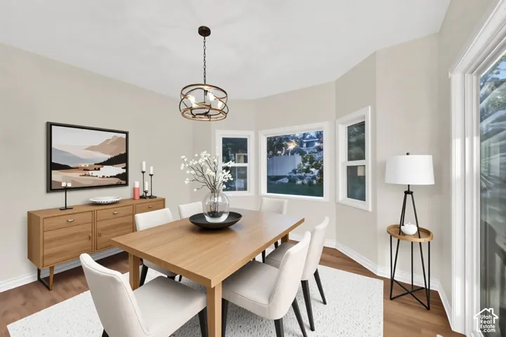 Bay window with multiple panes, wood-finish flooring, recessed lighting, and a modern drum pendant light fixture