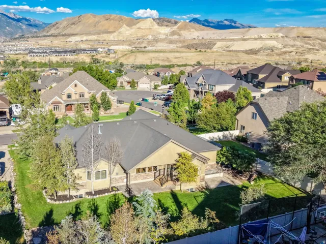 Residential neighborhood with established homes and mature landscaping, set against a backdrop of distant mountains