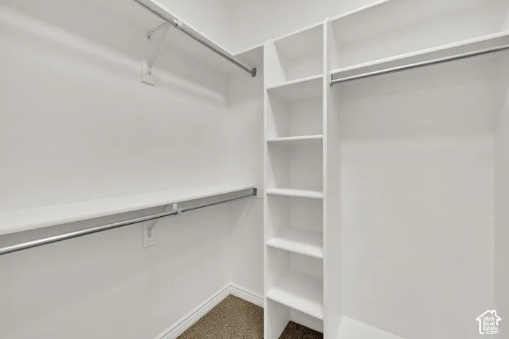 Built-in shelving, multiple hanging rods, and ample storage space