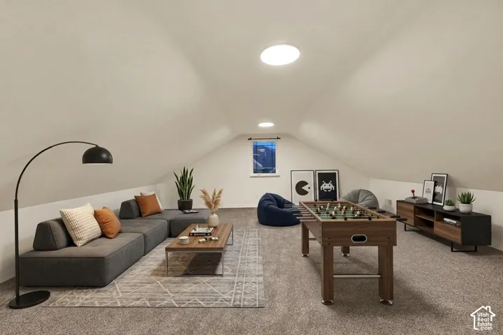 Carpeted room with sloped ceilings, recessed lighting, and a single window