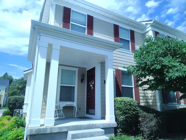 Multi-story dwelling featuring horizontal siding with contrasting shutters