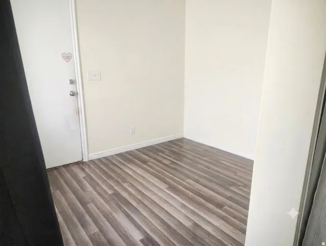Wood-finish flooring with light-colored walls and white trim