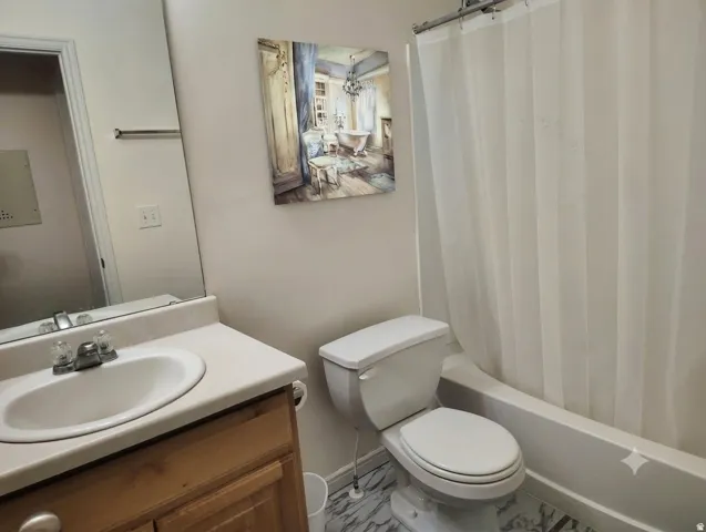 Vanity with an integrated sink, polished chrome faucet, and wood-finish cabinetry