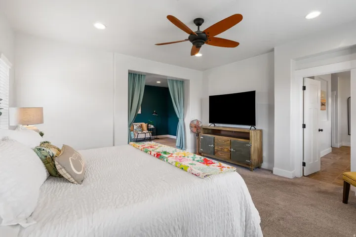 Recessed lighting, wood-finish ceiling fan, and white trim throughout