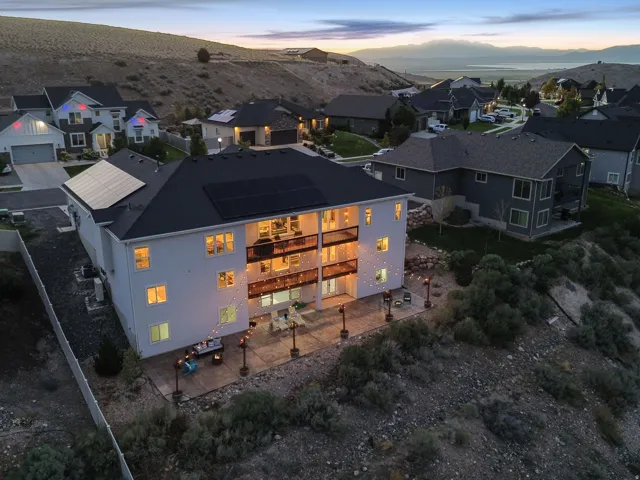 Two-story residence featuring a dark shingle roof and solar panels