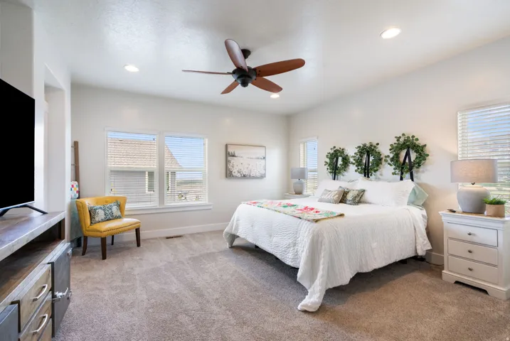 Recessed lighting, ceiling fan, multiple windows, soft carpet flooring, and white painted walls
