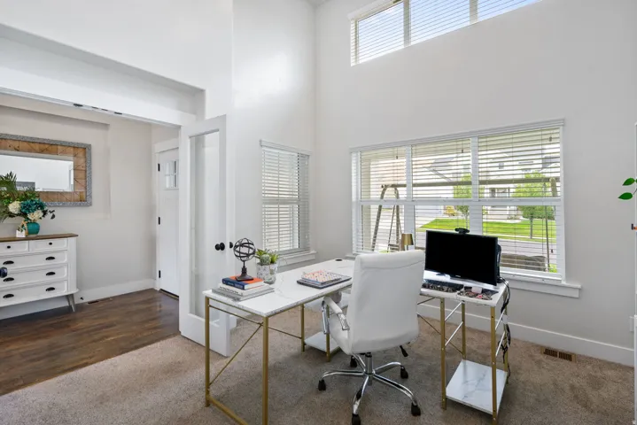 Argon gas filled windows, High ceilings with  large windows with blinds, wood-finish flooring, and a glass-paneled interior door