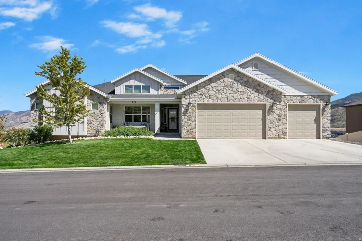 Stone and stucco exterior with a 3i-car garage