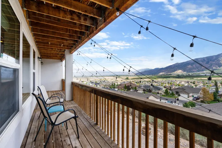 Expansive outdoor balcony with wood decking and railing