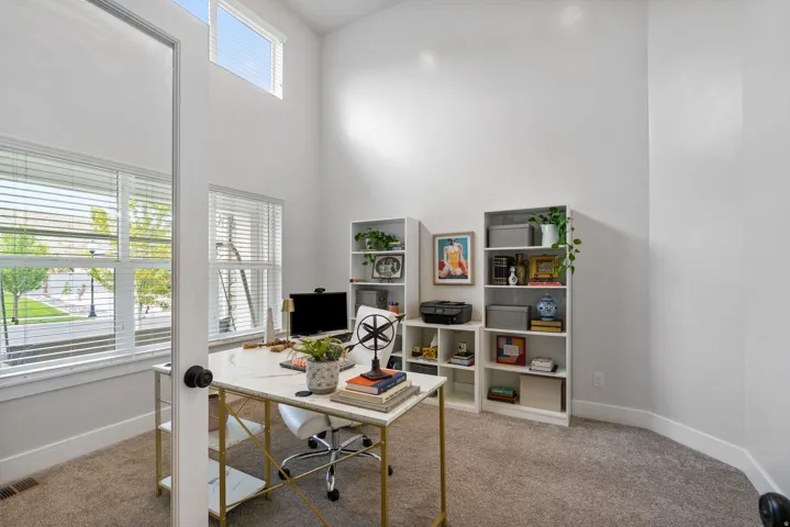 Argon gas filled windows, Bright home office, carpet flooring, abundant natural light from large windows
