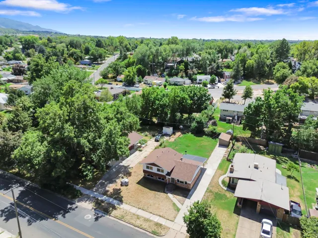 Property with mature landscaping and a green lawn