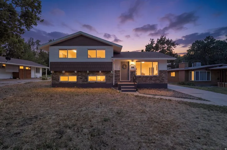 Multi-level exterior featuring horizontal siding, stone veneer, and shake shingles