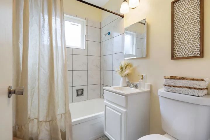 White subway tile shower surround with integrated bathtub